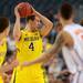 Michigan freshman Mitch McGary looks to pass the ball during the first half against Florida at Cowboys Stadium on Sunday, March 31, 2013. Melanie Maxwell I AnnArbor.com